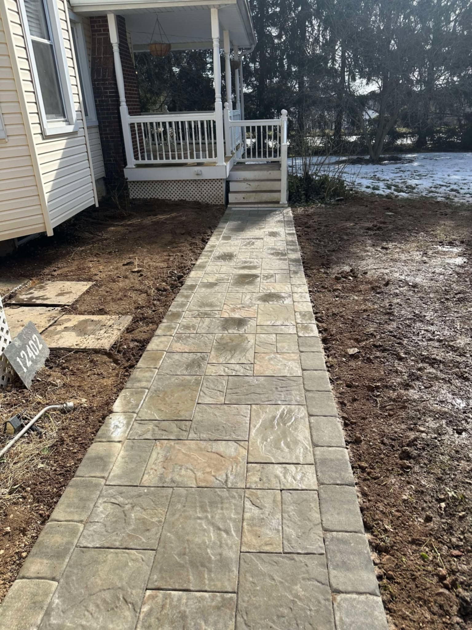 Hardscaping Services 2 Straight paver walkway with a contrasting border leading to porch steps